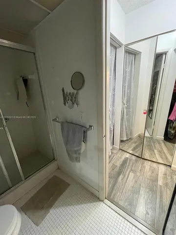 a bathroom with a glass shower door