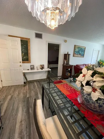 a very nice looking bedroom with a large bed and a chandelier
