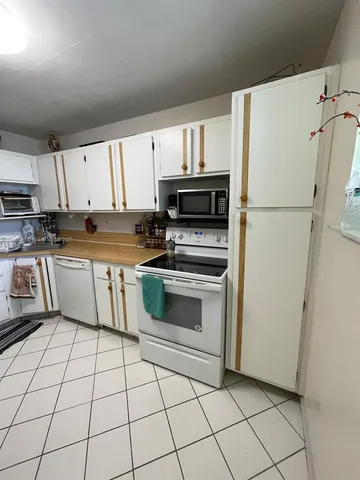 a kitchen with a stove a sink and a refrigerator