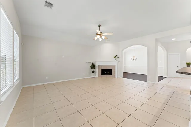 an empty room with fireplace and windows