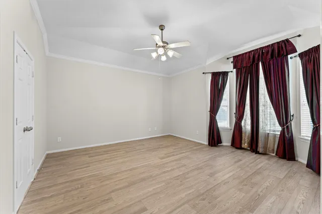 a view of an empty room with wooden floor