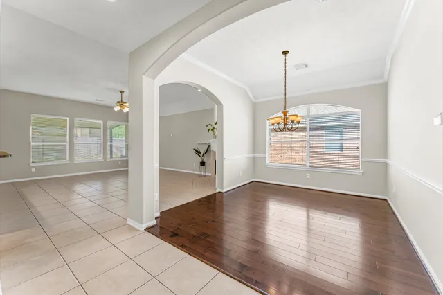 a view of an empty room with window and cabinet