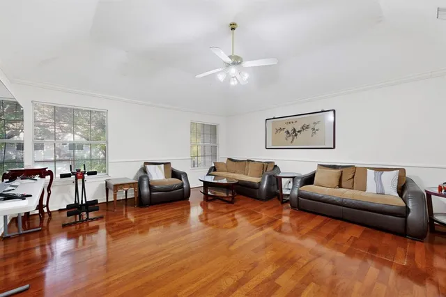 a living room with furniture and wooden floor