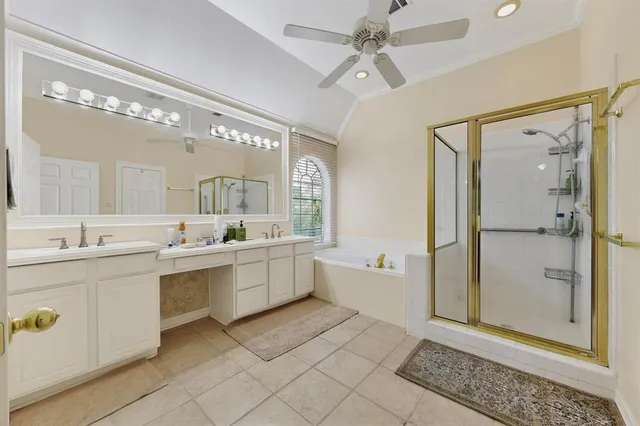 a large bathroom with a double vanity sink a mirror and a bathtub