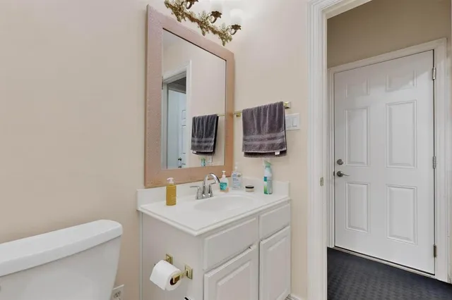 a bathroom with a sink a toilet and mirror
