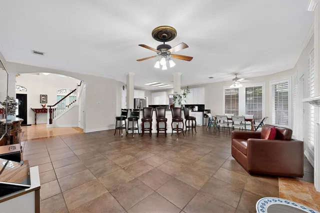 a gym room with lots of furniture and a chandelier