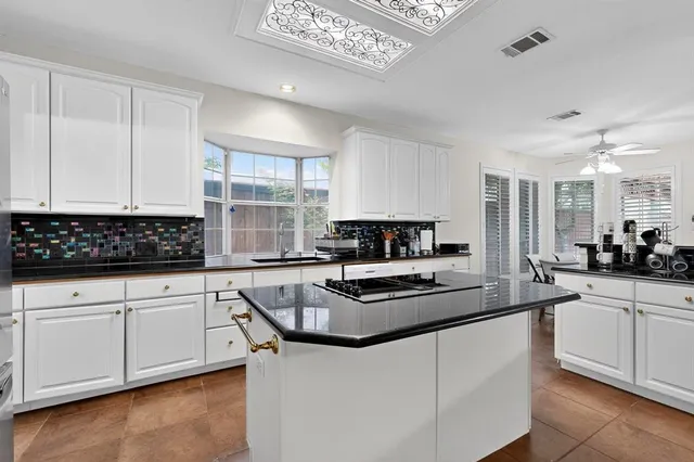 a kitchen with stainless steel appliances granite countertop a stove and a sink