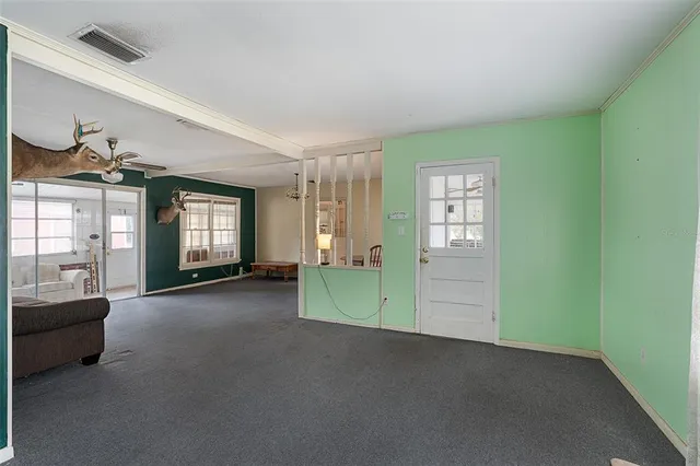 an empty room with furniture and window