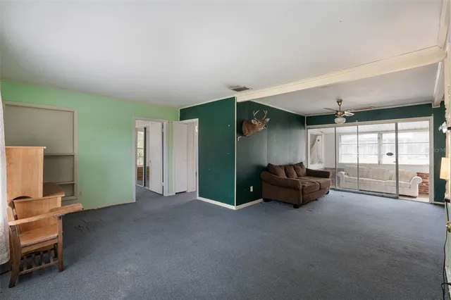 a view of a livingroom with furniture and a window