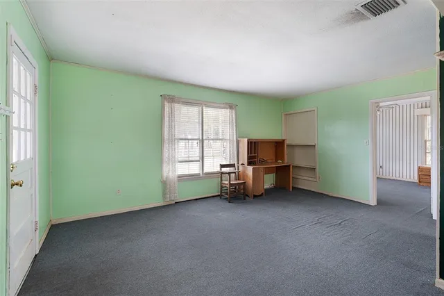 a view of room with window and furniture