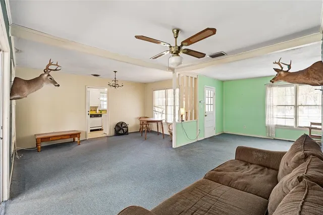 a living room with furniture and a chandelier