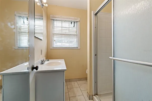 an aerial view of a house with a garden and trees