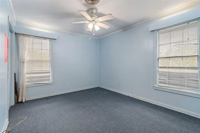 an aerial view of residential houses with outdoor space and trees