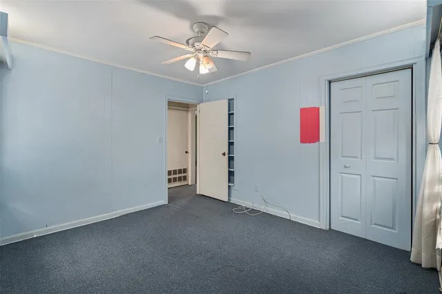 an aerial view of residential houses with outdoor space and trees