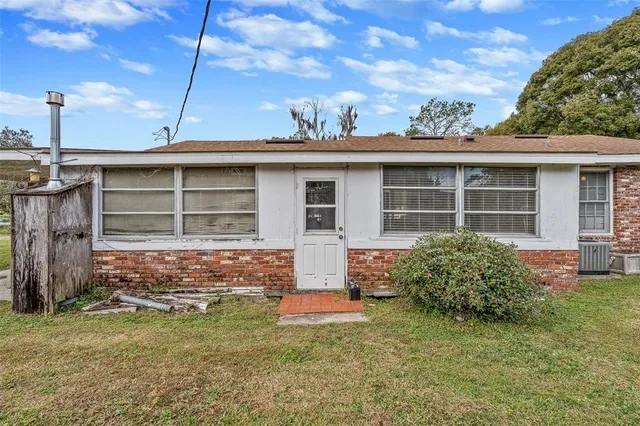 an aerial view of residential houses with outdoor space and swimming pool