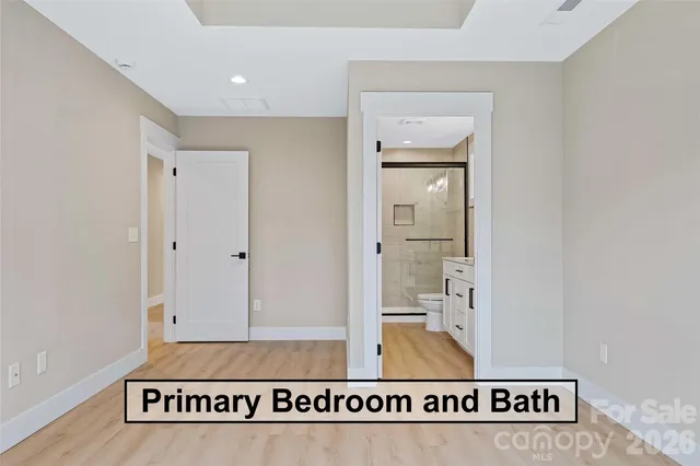 a bedroom with a large bed and a flat tv screen on dresser