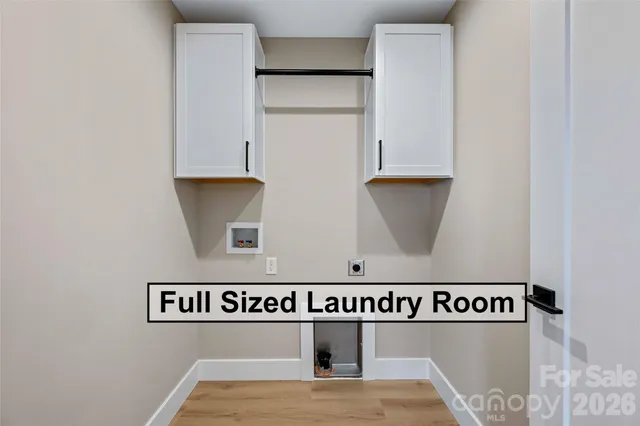 a view of washer and dryer with kitchen in the background