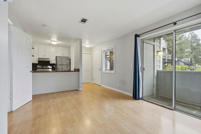 a view of kitchen with refrigerator and window