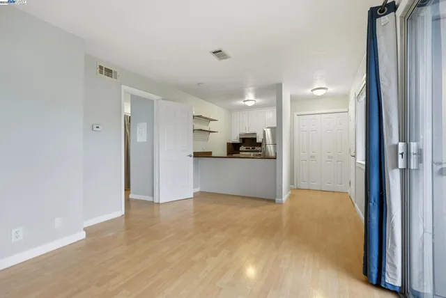 a view of a kitchen with a refrigerator and a sink