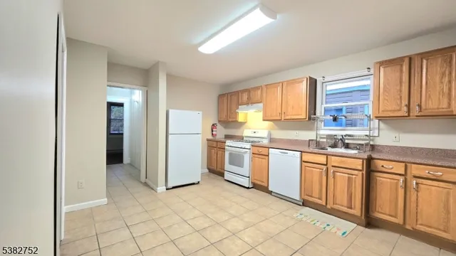 a kitchen with granite countertop cabinets and steel stainless steel appliances