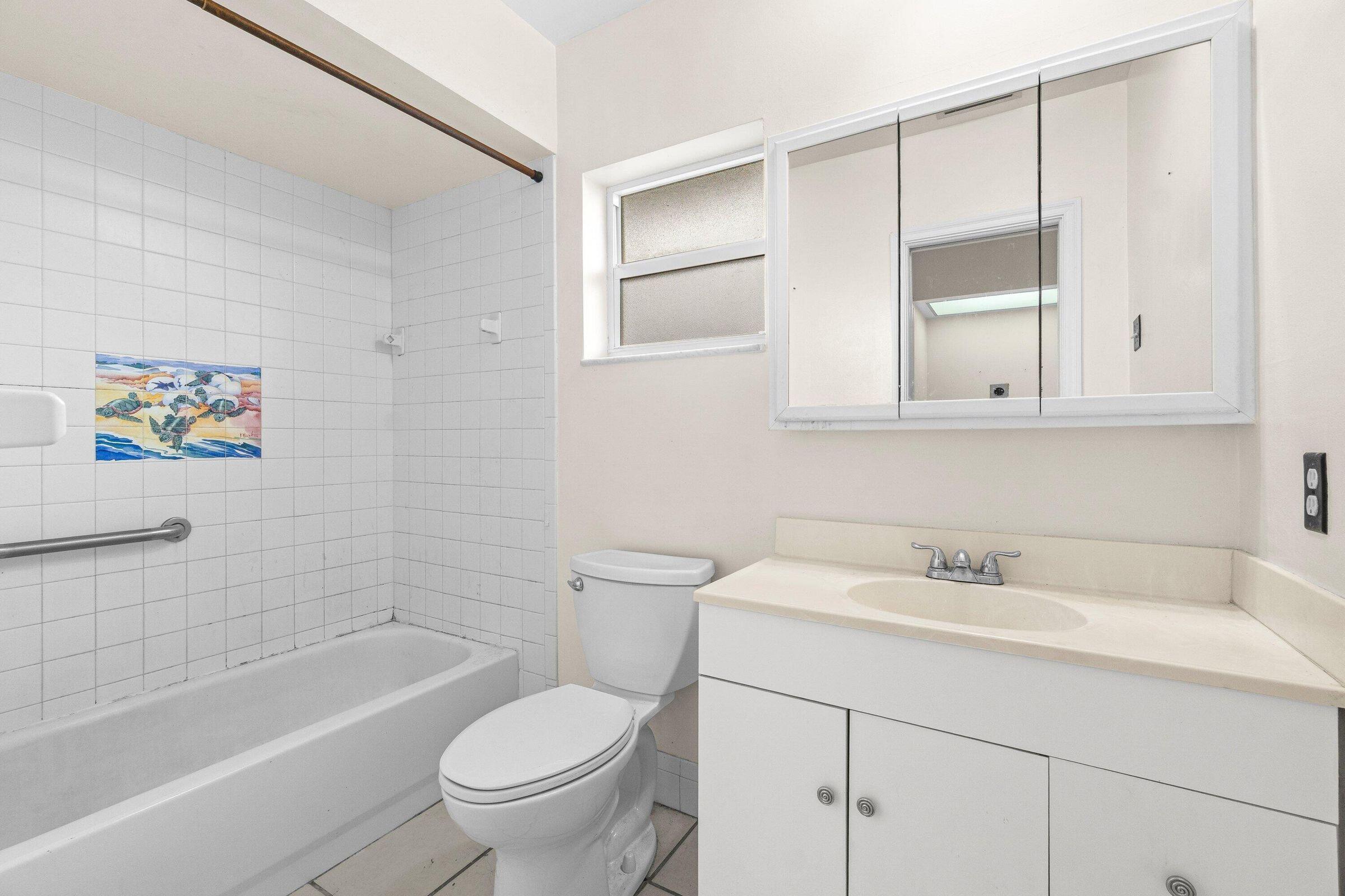 921 Southwest 11th Terrace Boca Raton, FL 33486 - Photo 19 of 26 a bathroom with a sink a toilet and a bathtub