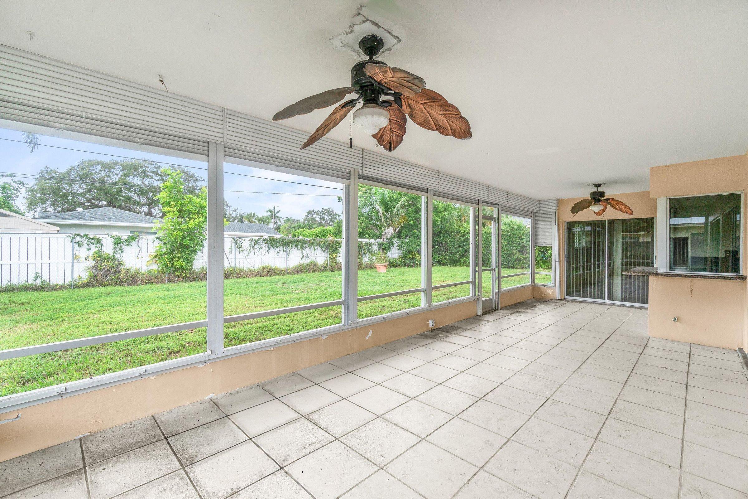 921 Southwest 11th Terrace Boca Raton, FL 33486 - Photo 20 of 26 a view of a room with wooden floor and windows