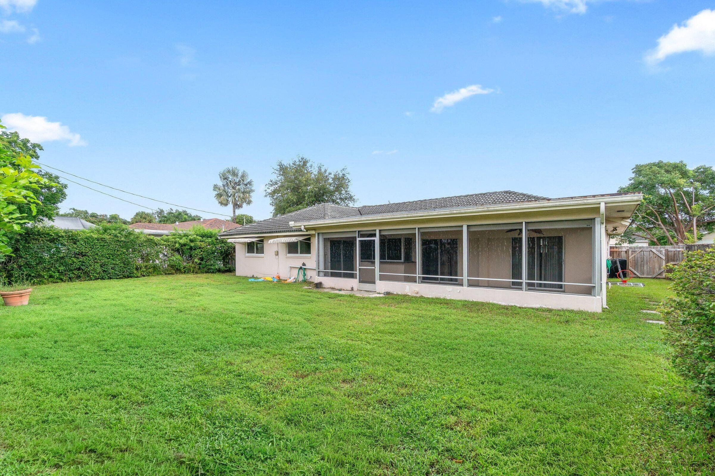 921 Southwest 11th Terrace Boca Raton, FL 33486 - Photo 2 of 26 a front view of a house with a garden