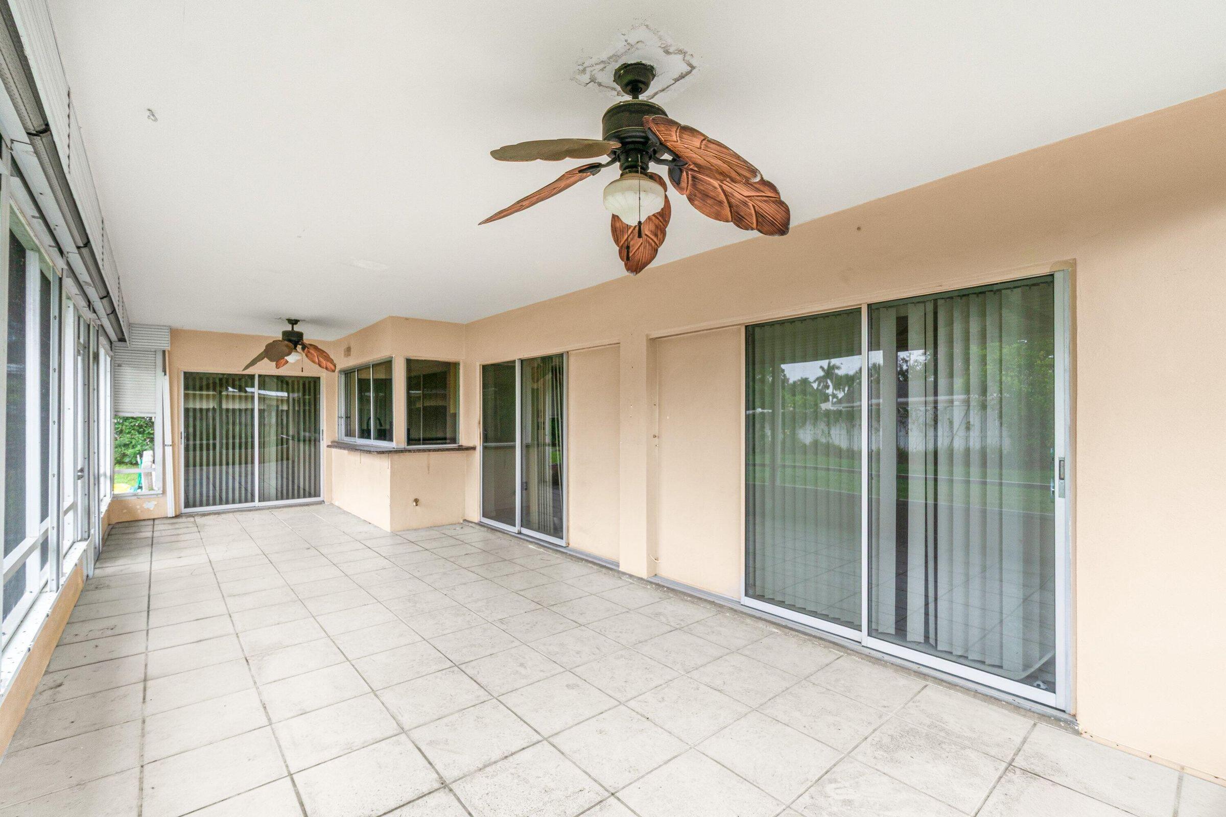 921 Southwest 11th Terrace Boca Raton, FL 33486 - Photo 21 of 26 a view of a room with a ceiling fan and window