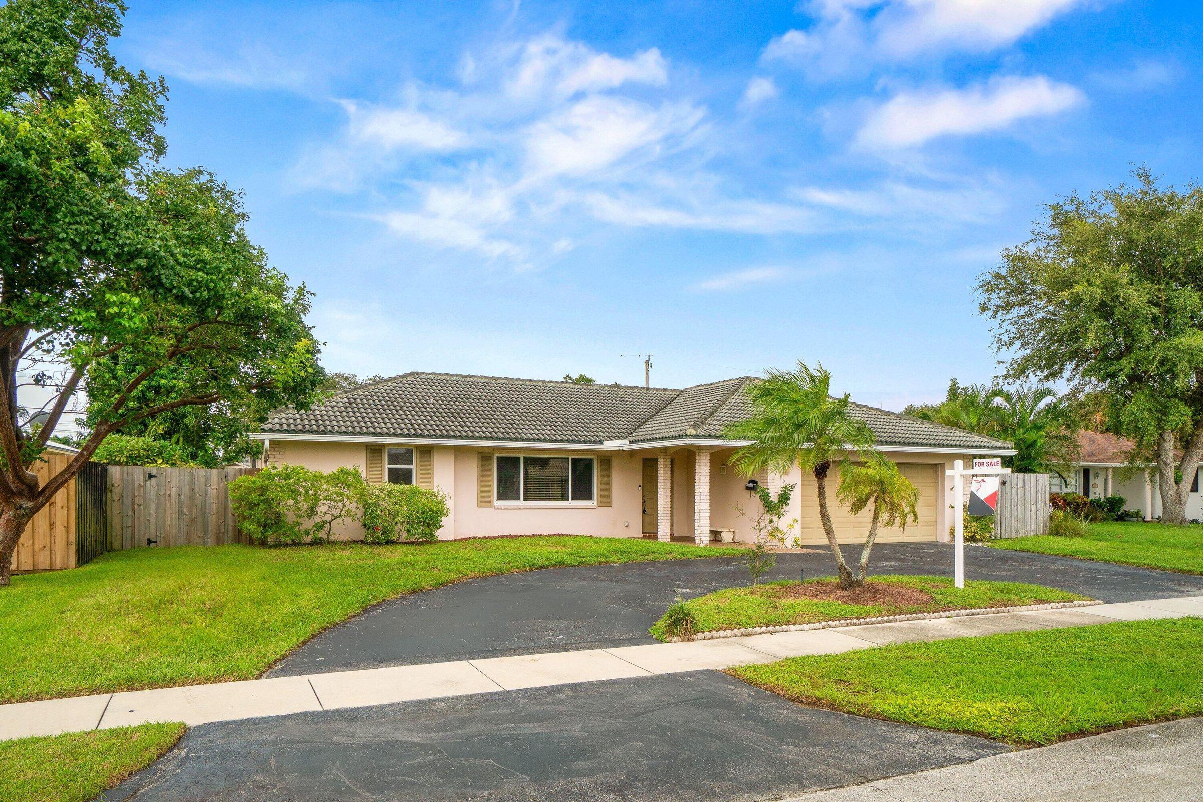 921 Southwest 11th Terrace Boca Raton, FL 33486 - Photo 24 of 26 a front view of a house with a yard