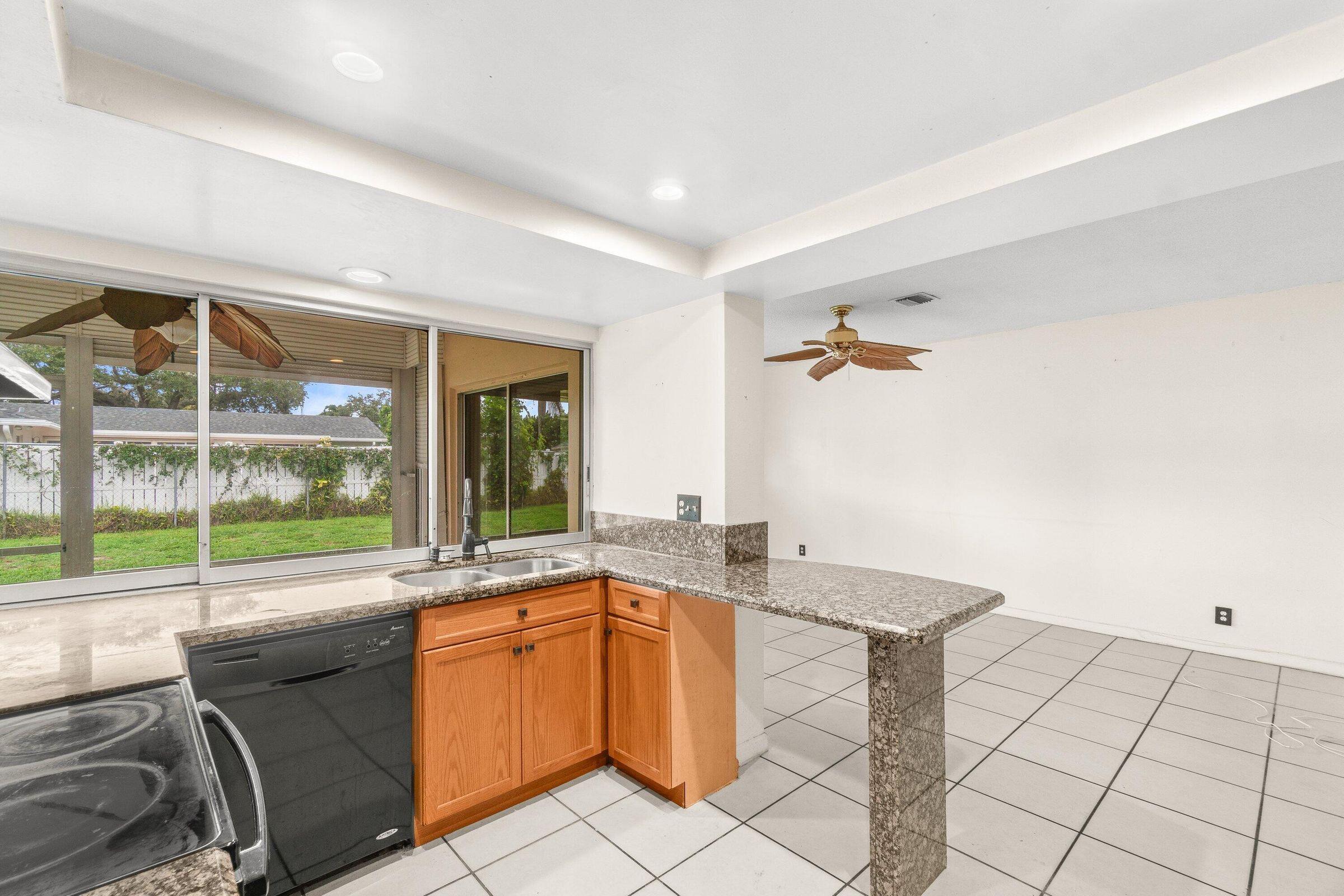 921 Southwest 11th Terrace Boca Raton, FL 33486 - Photo 6 of 26 a view of a kitchen with a sink and cabinets