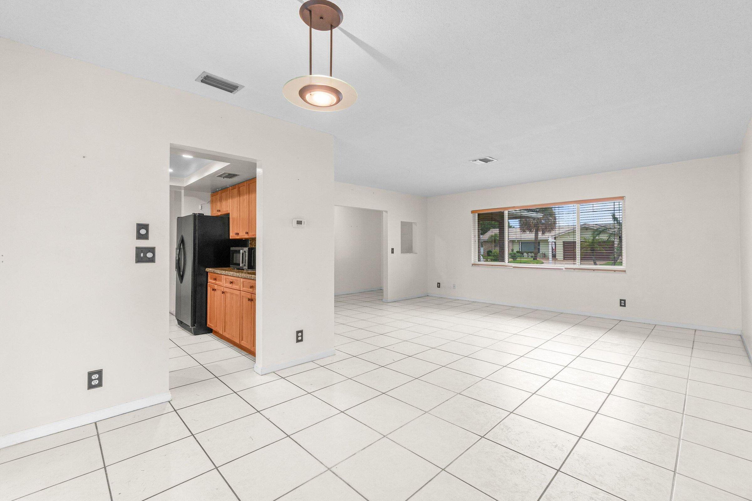 921 Southwest 11th Terrace Boca Raton, FL 33486 - Photo 7 of 26 a view of a livingroom with an empty space and a window