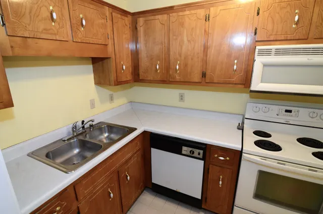 a kitchen with a sink a stove and cabinets