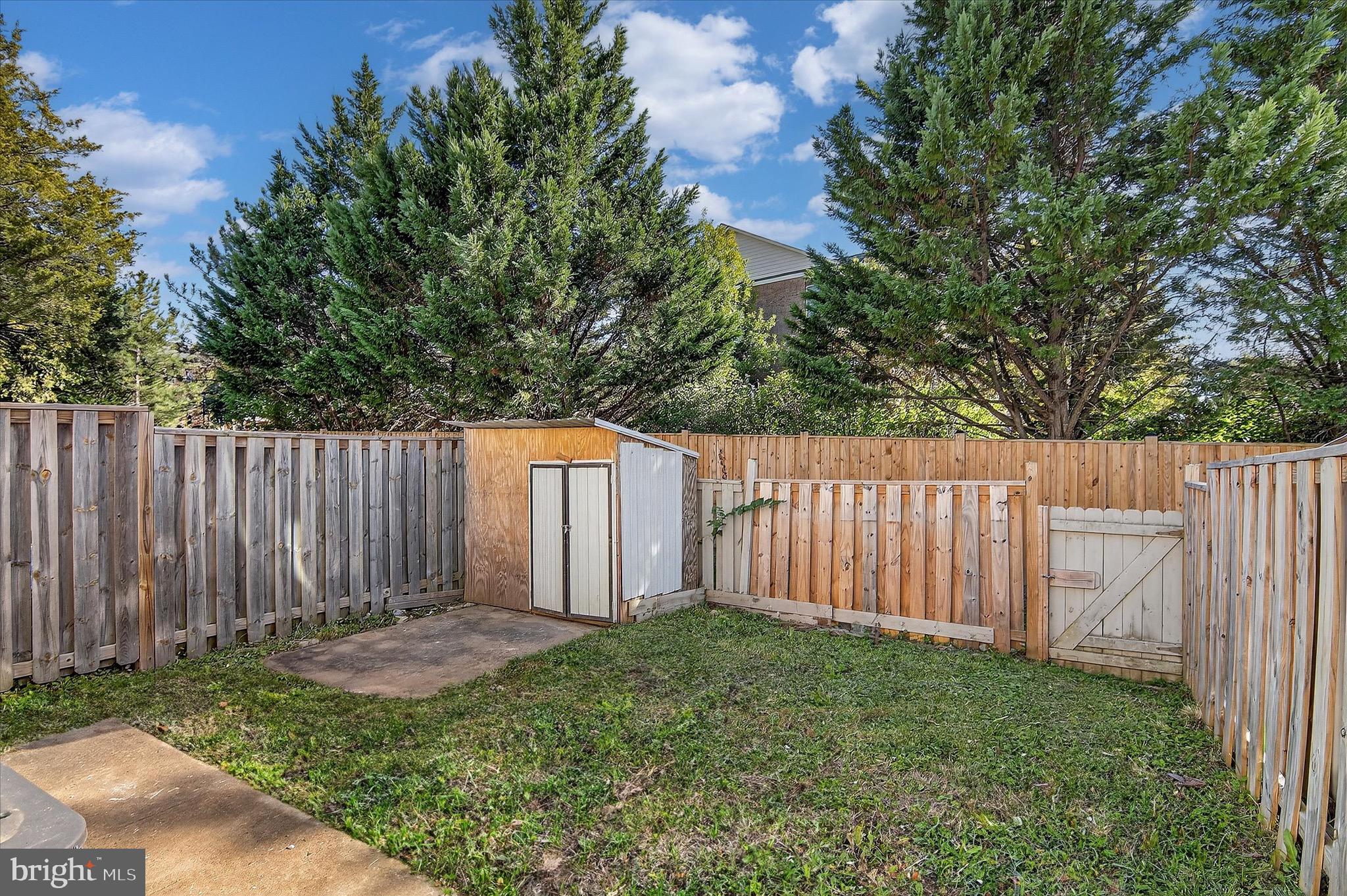 402 Reneau Way Herndon, VA 20170 - Photo 12 of 31 a view of backyard with large trees and wooden fence