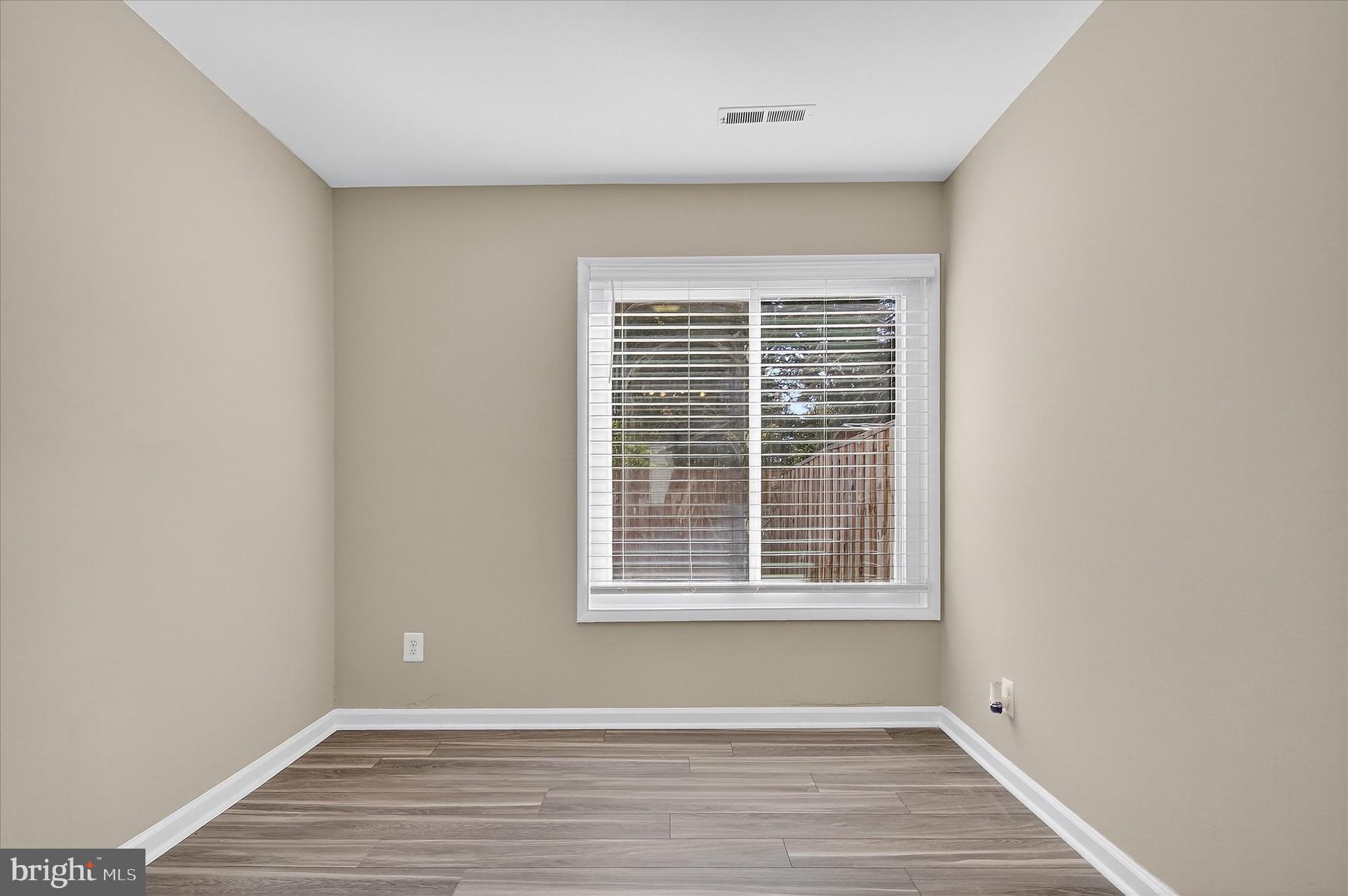 402 Reneau Way Herndon, VA 20170 - Photo 13 of 31 a view of an empty room with wooden floor and a window