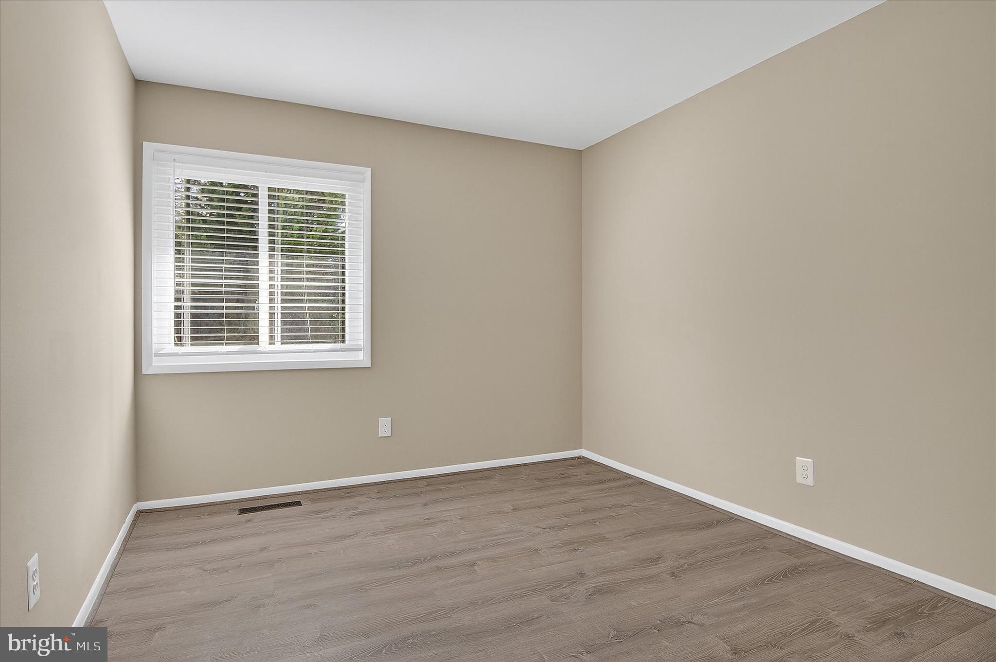 402 Reneau Way Herndon, VA 20170 - Photo 17 of 31 a view of an empty room with wooden floor and a window