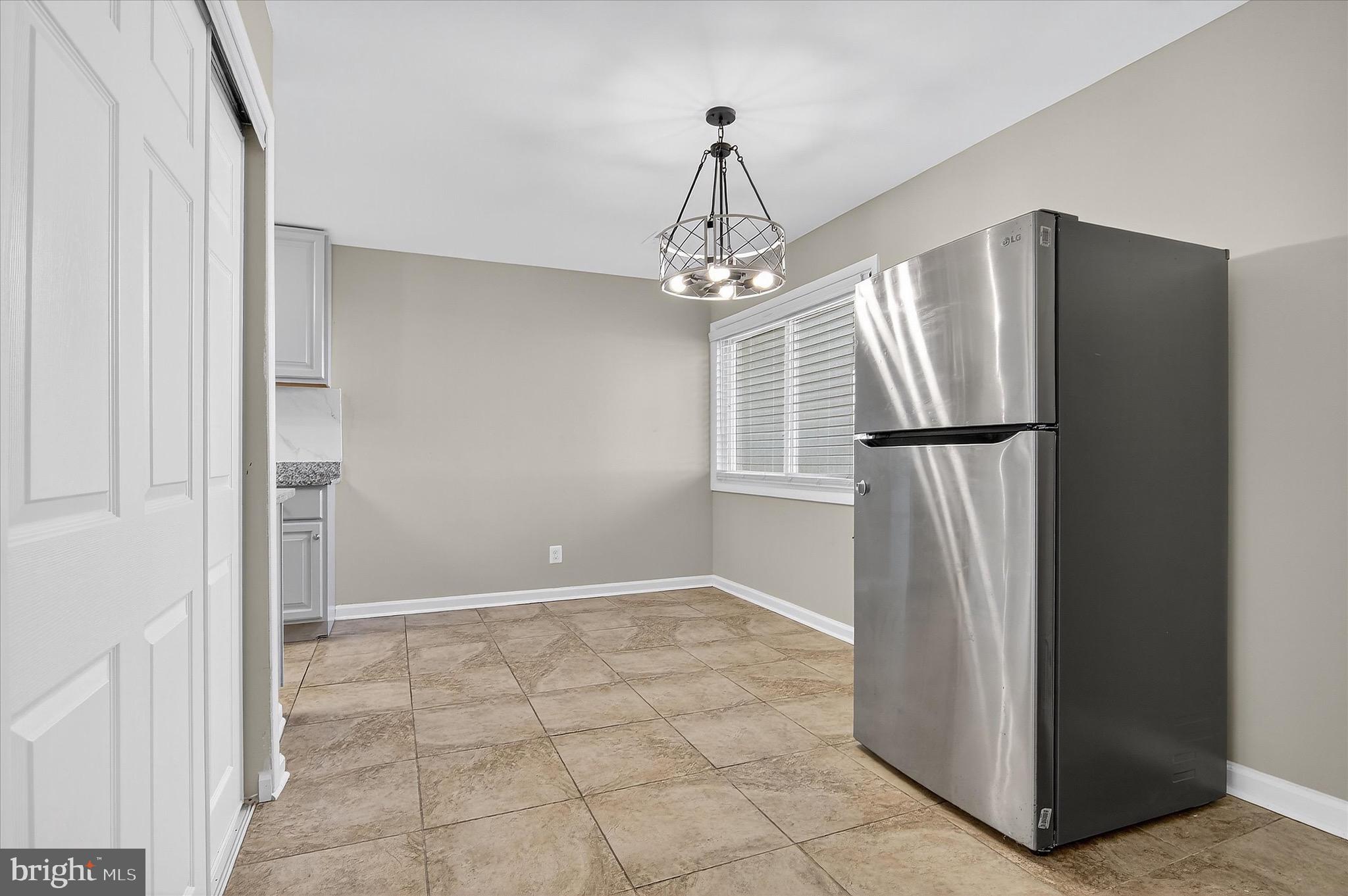 402 Reneau Way Herndon, VA 20170 - Photo 21 of 31 a view of a refrigerator in kitchen and white cabinets