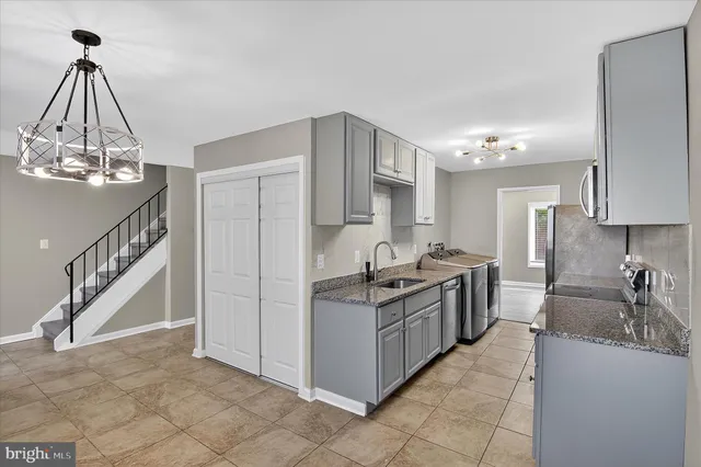 a kitchen with stainless steel appliances granite countertop a sink and cabinets