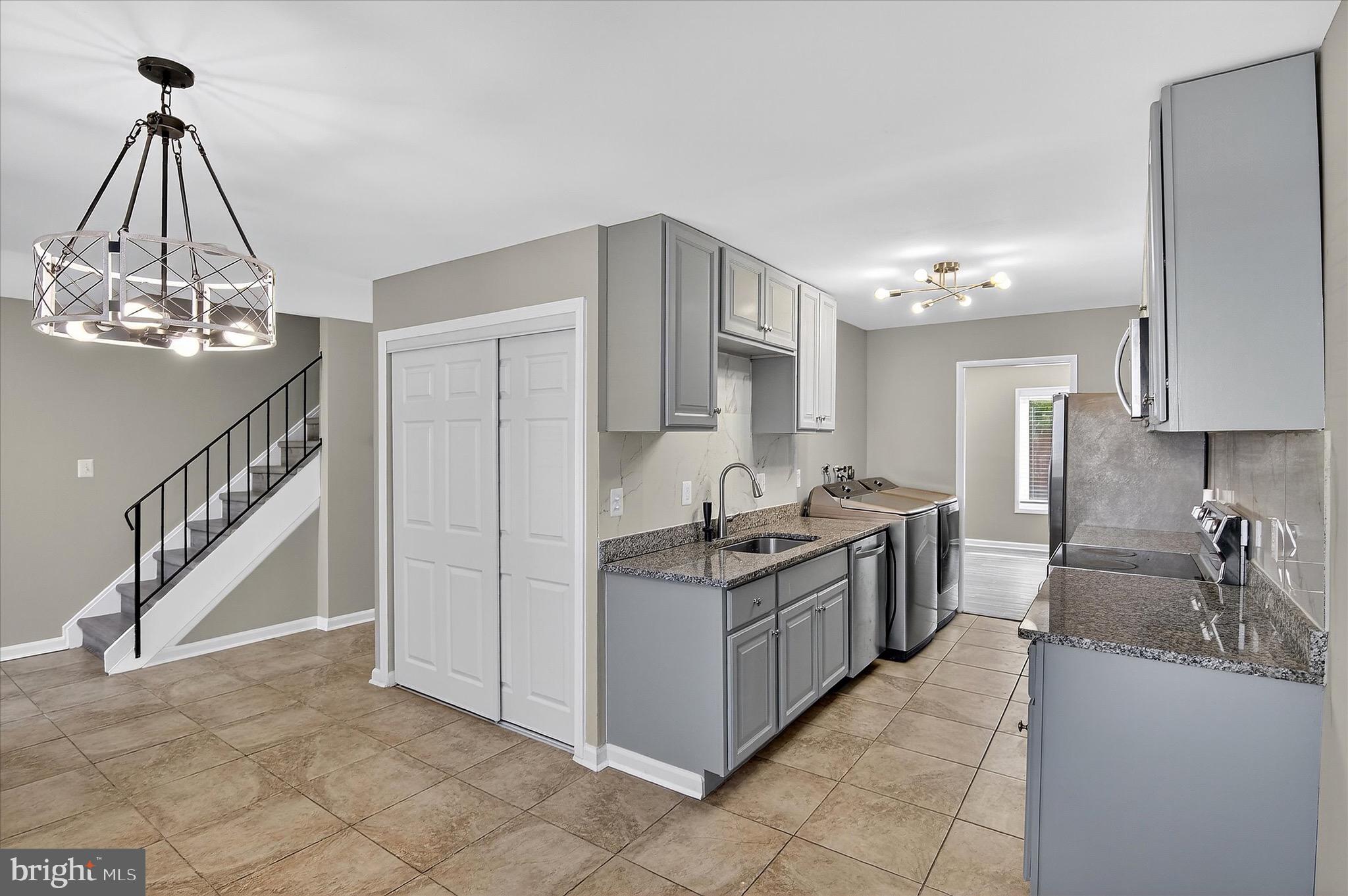 402 Reneau Way Herndon, VA 20170 - Photo 24 of 31 a kitchen with stainless steel appliances granite countertop a sink and cabinets