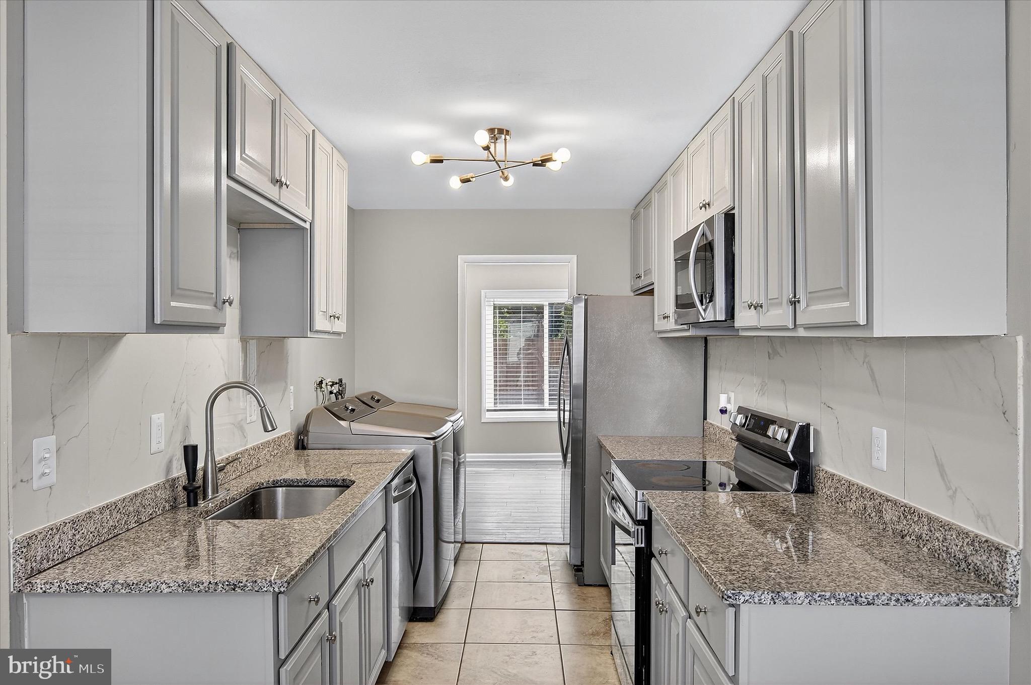 402 Reneau Way Herndon, VA 20170 - Photo 25 of 31 a kitchen with stainless steel appliances granite countertop a sink stove and cabinets