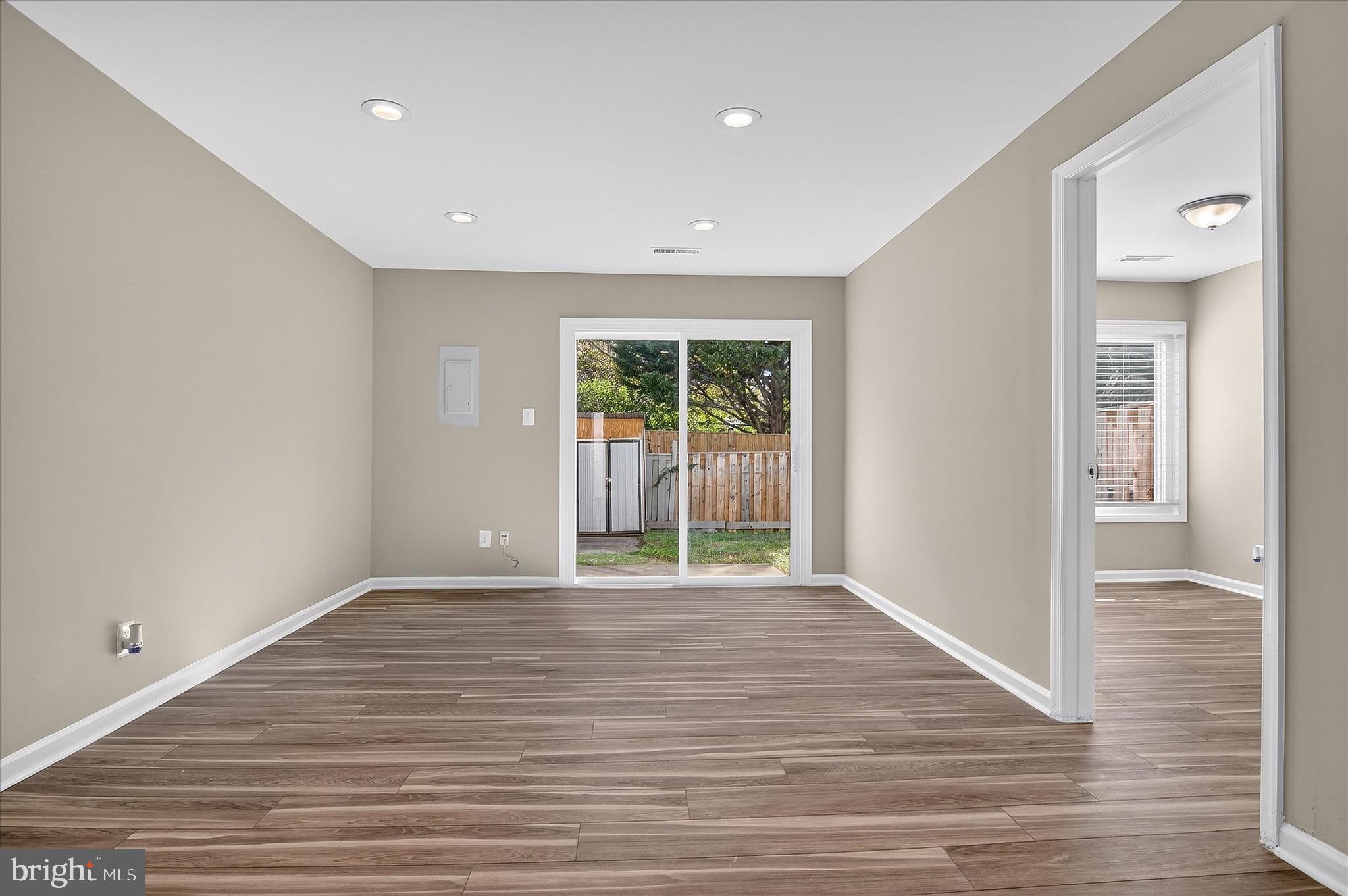 402 Reneau Way Herndon, VA 20170 - Photo 3 of 31 a view of an empty room with wooden floor and a window