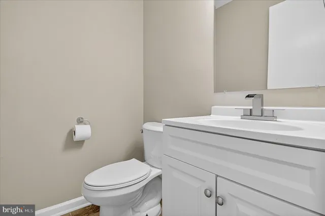 a bathroom with a sink toilet and a mirror