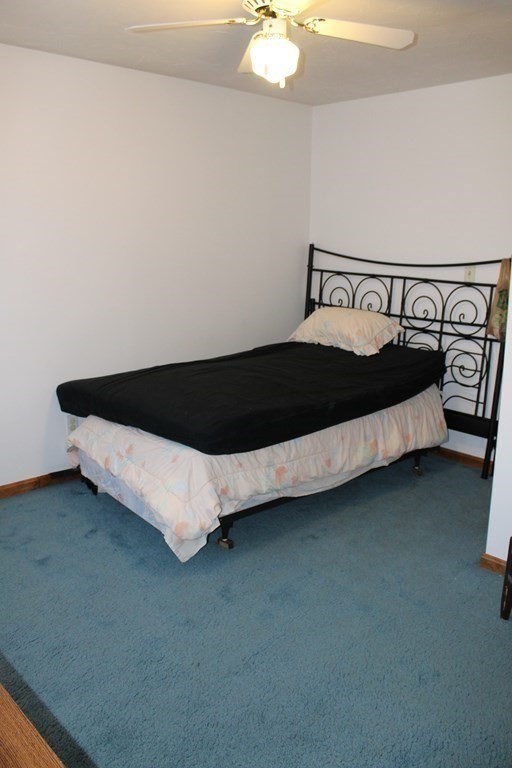 5 Lower Road Hudson, MA 01749 - Photo 12 of 30 a bed sitting in a bedroom next to a lamp