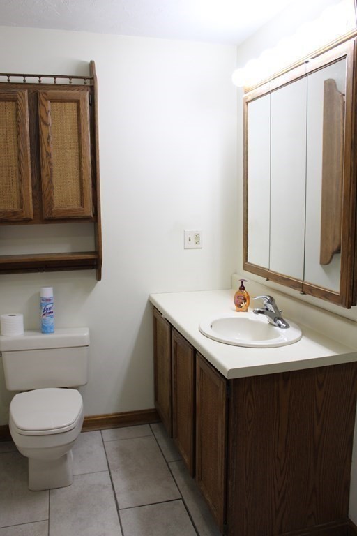5 Lower Road Hudson, MA 01749 - Photo 17 of 30 a bathroom with a sink a toilet and mirror