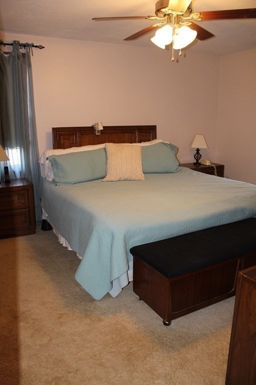 5 Lower Road Hudson, MA 01749 - Photo 18 of 30 a bed sitting in a bedroom and chandelier