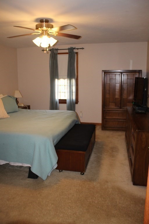 5 Lower Road Hudson, MA 01749 - Photo 19 of 30 a bedroom with a bed and a chandelier