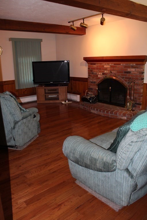 5 Lower Road Hudson, MA 01749 - Photo 8 of 30 a living room with furniture and a fireplace