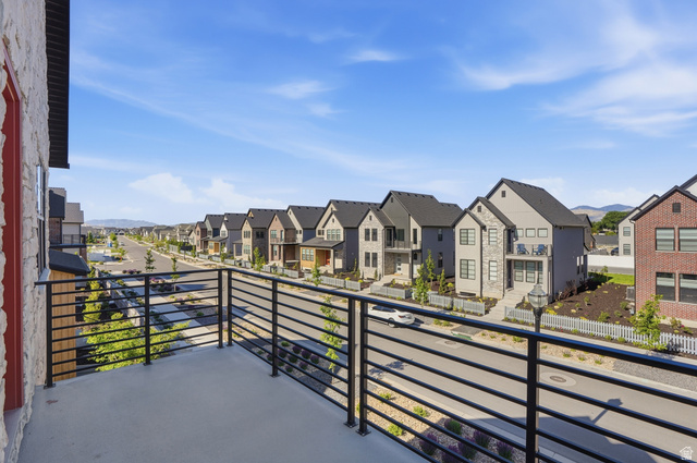 11531 Engelmann Drive Draper, UT 84020 - Photo 28 of 31 Balcony with horizontal railing overlooking a street lined with contemporary homes