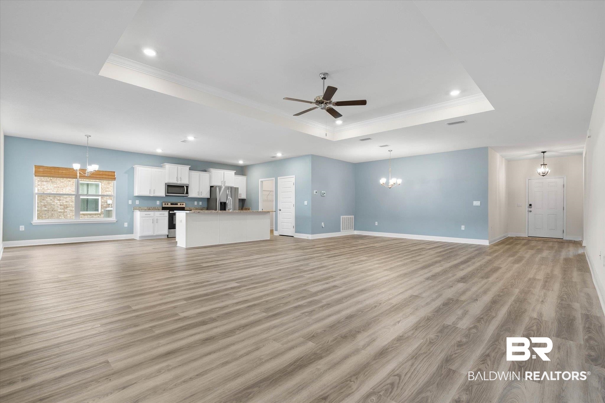 11229 Genuine Risk Circle Daphne, AL 36526 - Photo 5 of 46 Living room with a raised ceiling, LVP finished floors, recessed lighting, open concept.