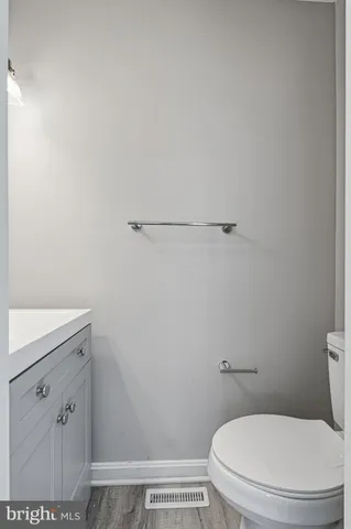 a picture of a bench in front of a white house