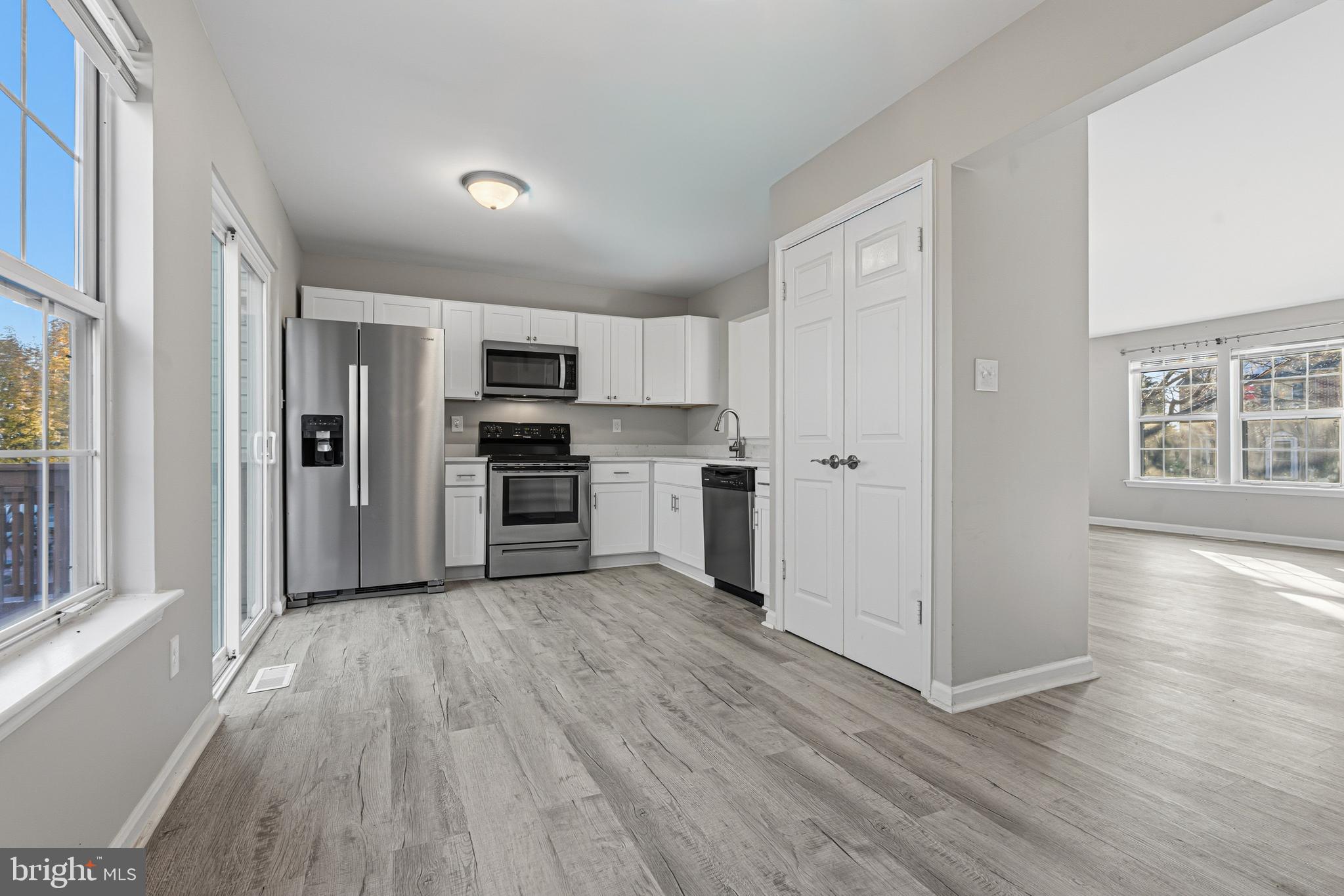 3365 Cheverly Court, Unit 3365 Abingdon, MD 21009 - Photo 8 of 32 a view of a kitchen with a refrigerator wooden floor and a window